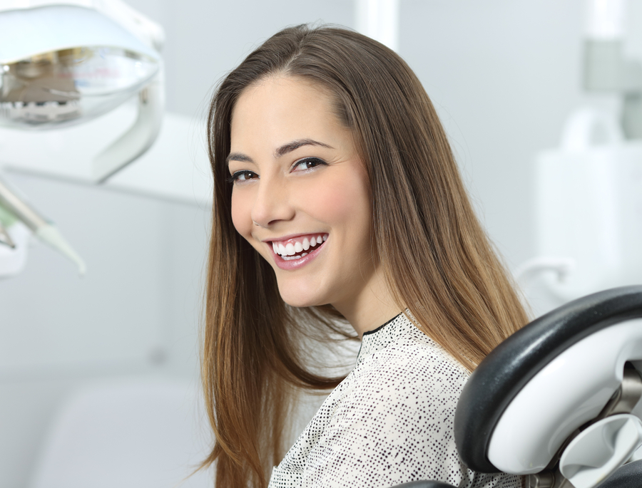 Patient smiling after dental bridge treatment at clinic