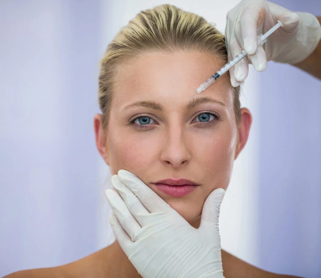 Female patient receiving a botox injection in forehead