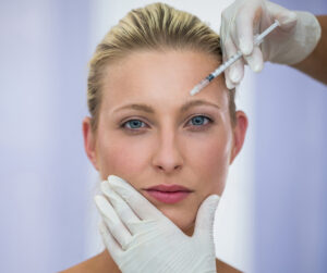 Female patient receiving botox injection for forehead lines
