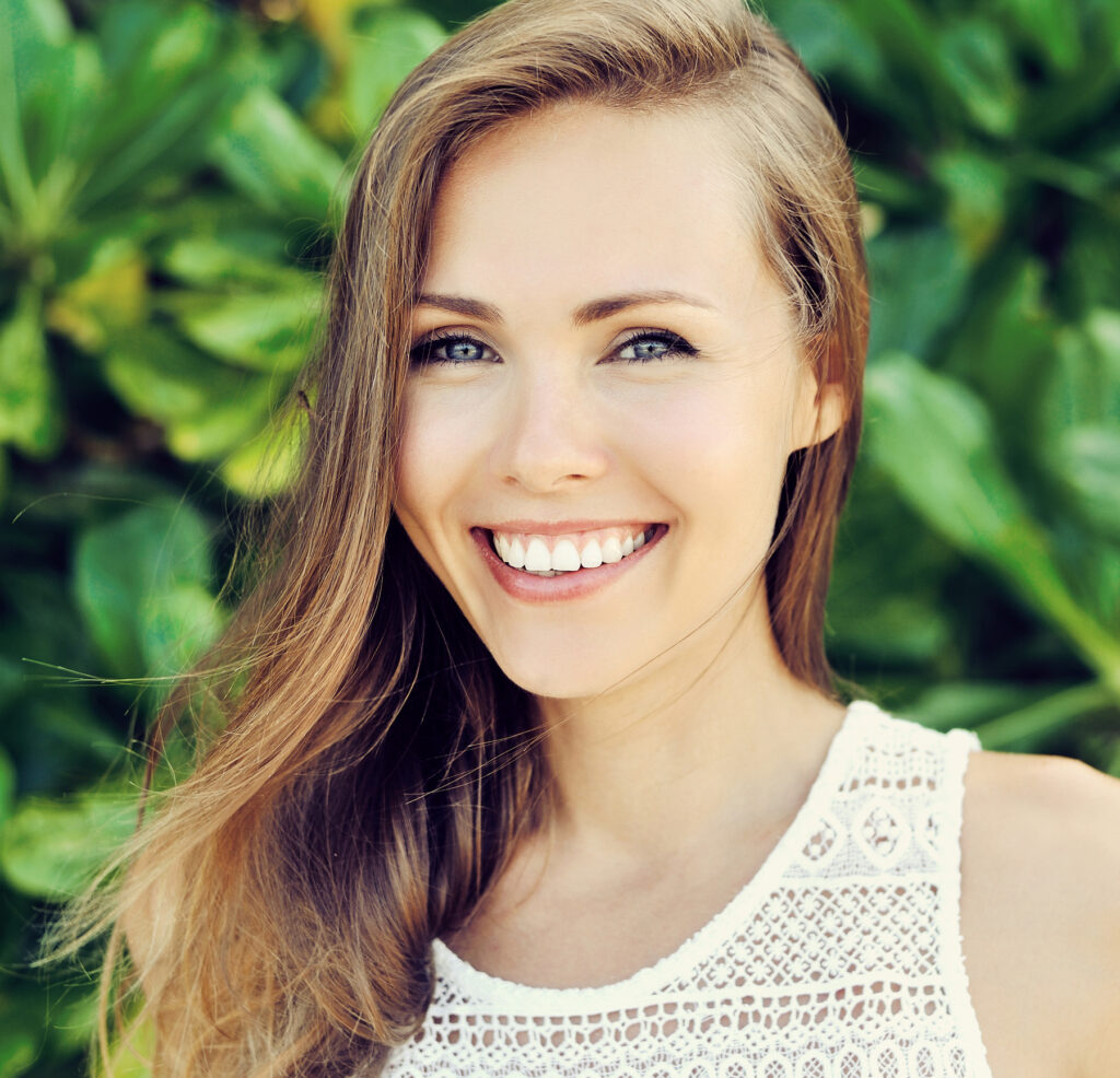 Closeup of a young woman smiling with healthy gums