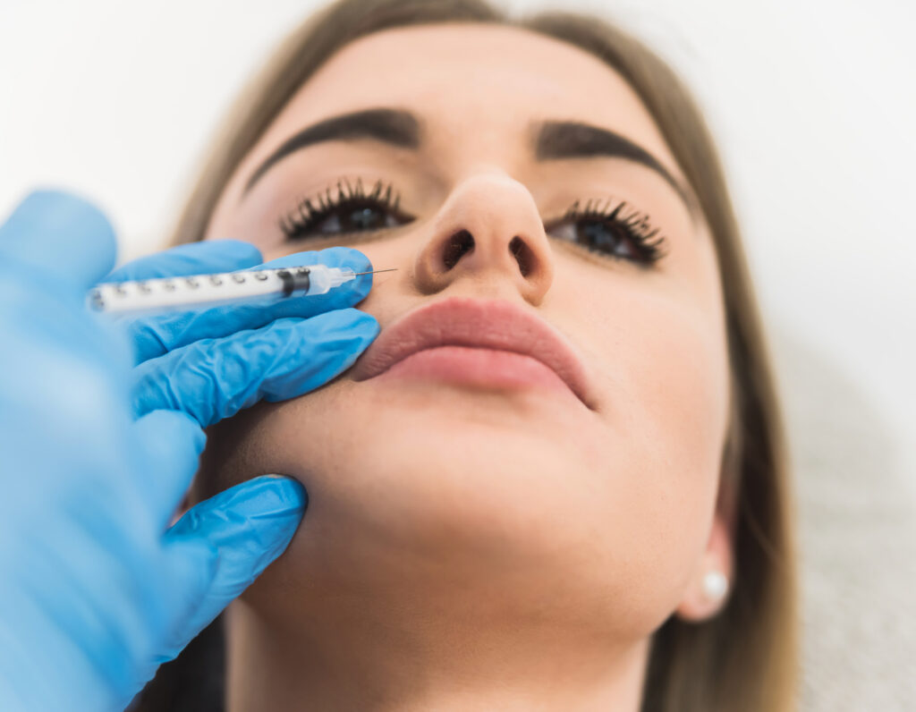 Woman receiving fillers for gummy smile treatment