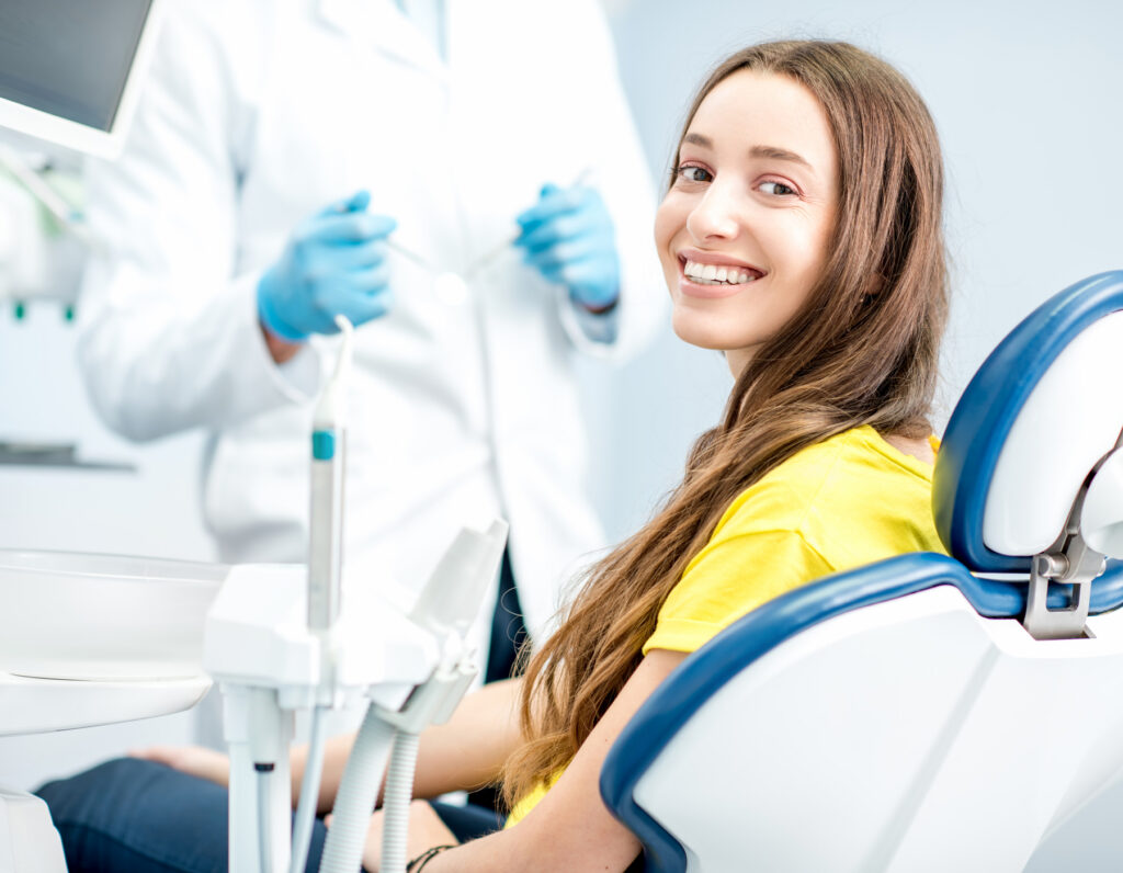 Happy female patient smiling at the dental clinic