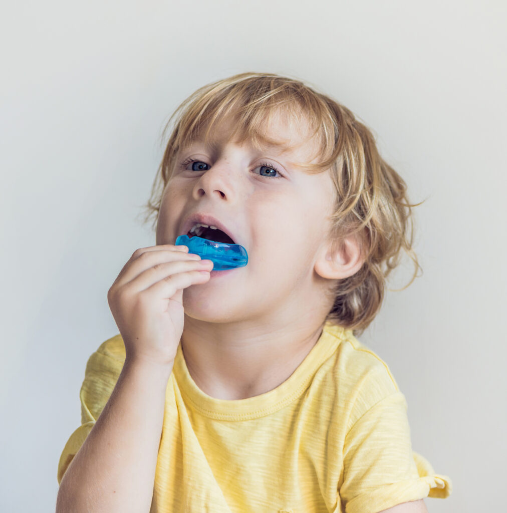 Three-year-old boy with myofunctional trainer in mouth