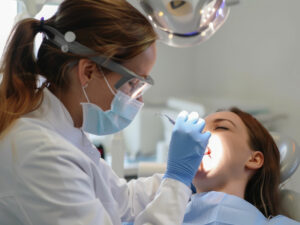 Dentist performing an oral cancer screening exam