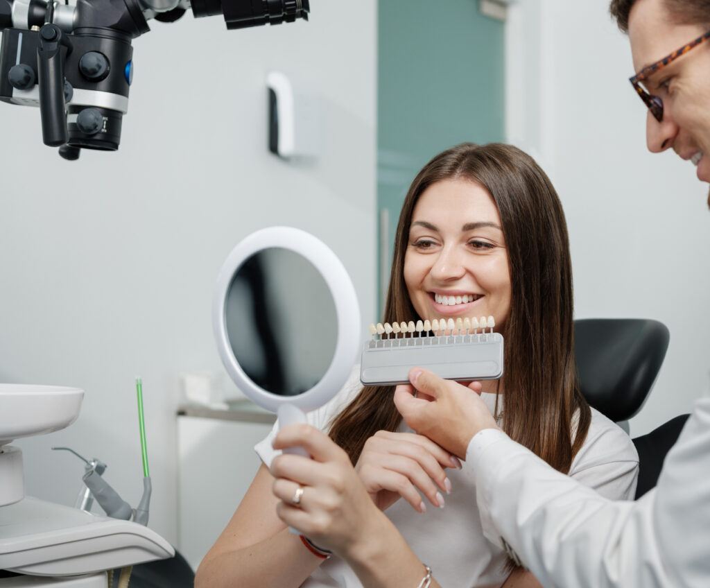 Dentist showing veneer color options to patient