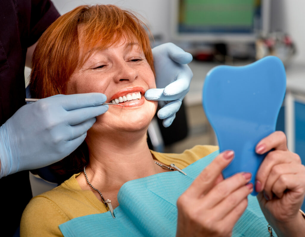 Senior woman consulting in a dental office about implants