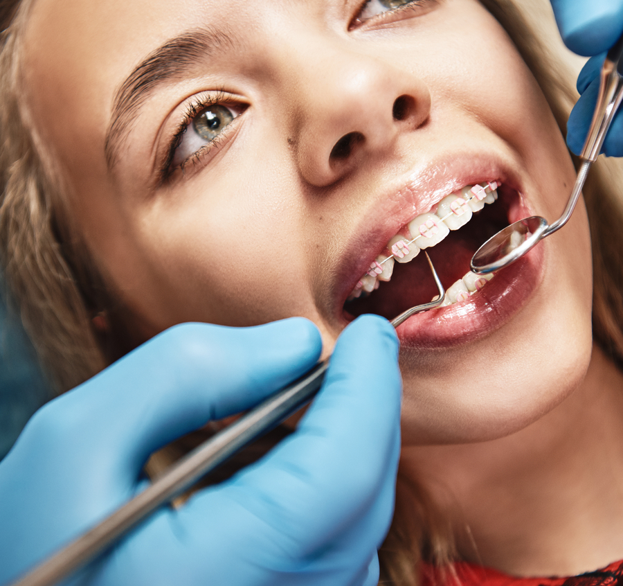 Dentist examining a girl's teeth in a dental clinic