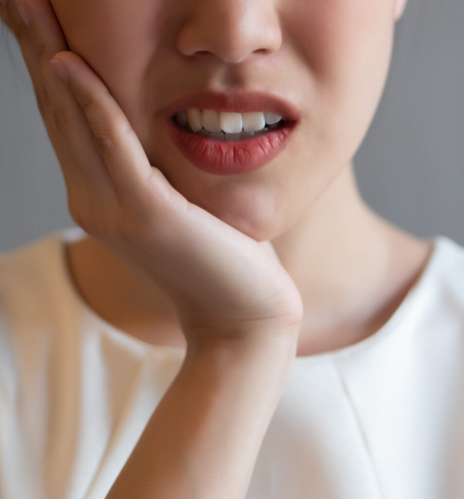 Asian woman experiencing severe toothache and pain